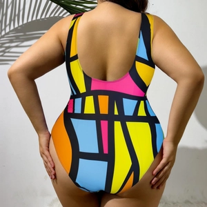 One-piece plus size swimsuit with bold geometric color block patterns and a low back cut