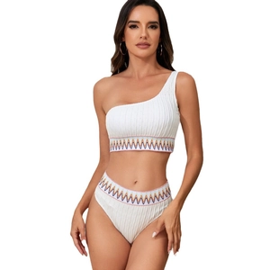 White one-shoulder bikini set with high-waisted bottoms and colorful wave embroidery