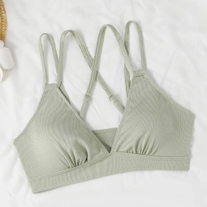 Detail of light green ribbed bikini top with cross-back straps on white background