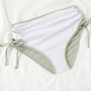 Detail of sage green ribbed high-waisted bikini bottom with adjustable side drawstrings