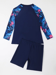 Detail of long sleeve sun protection swim top with tropical leaf and floral print