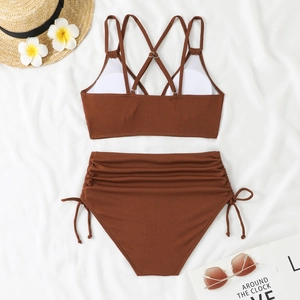 Flat lay of brown ribbed high waist bikini with side drawstring and crisscross back straps
