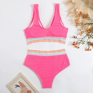 Detailed flat lay of pink textured bikini featuring colorful wavy elastic bands