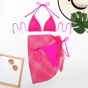 Detailed flat lay of rose red three-piece bikini set with mesh skirt and beach accessories