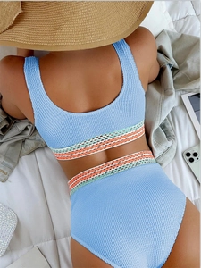 Detail of light blue textured high-waisted bikini set with colorful jacquard straps