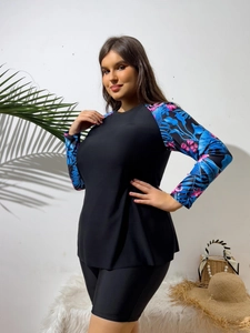 Detail of plus size long sleeve tankini with tropical floral print and black swim shorts