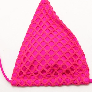 Detailed close-up of bright pink triangle bikini top with layered fishnet mesh texture