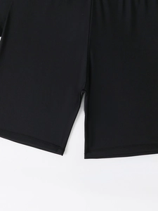 Detail of flatlock stitching and premium elastic fabric on black swim shorts