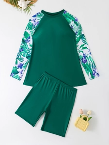 Flat lay of long sleeve tankini set with tropical palm leaf and purple flower prints