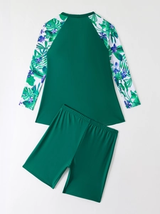 Detail of plus size long sleeve tankini set featuring tropical floral print and raglan sleeves
