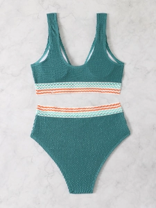 Flat lay of high-waist bikini set in dark teal seersucker with striped elastic bands