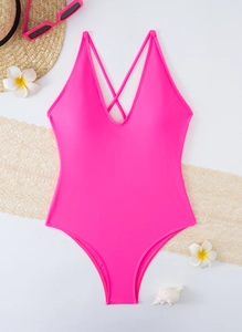 Flat lay of bright pink one-piece swimsuit with plunging V-neck and lace-up front detail