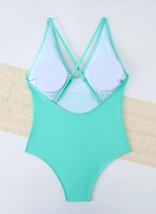 Detailed flat-lay of mint green one-piece swimsuit with cross-back straps and bra pads