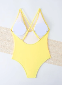 Detail of yellow one-piece swimsuit with criss-cross back straps and removable pads