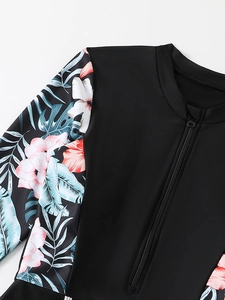 Detail of front zipper closure and floral pattern on long sleeve modest swimwear
