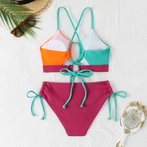 Flat lay of textured seersucker bikini with color-block top and magenta high waist bottom