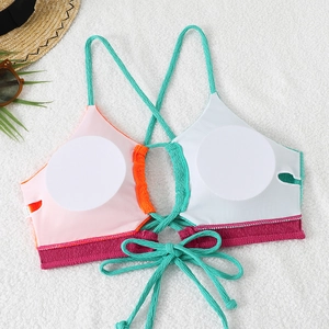 Detailed view of color-block bikini top with ribbed texture and white removable pads