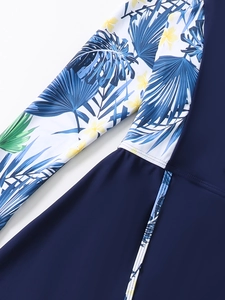 Detail of high-elasticity fabric with tropical floral print and precise stitching on swimwear