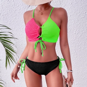 Detailed macro shot of textured seersucker fabric on color-block tie-front bikini set