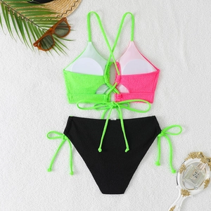 Detailed view of neon color block bikini top with textured fabric and tie-up design