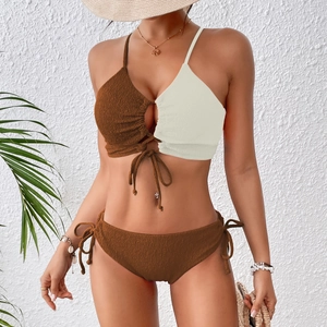 Detail of two-tone brown and beige bikini set featuring textured seersucker fabric finish
