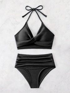 Flat lay of black ribbed bikini set with high-waisted ruched bottoms and twist top