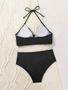 Detailed view of black ribbed texture bikini set with halter top on neutral background
