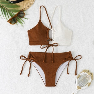 Flat lay of textured crinkle fabric bikini with contrast colors and tie-side details