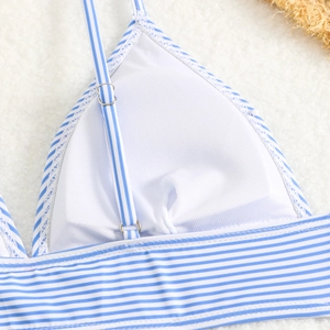 Close-up of blue and white striped bikini top with adjustable straps and silver buckle