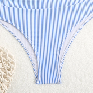 Close-up of blue and white striped bikini bottom with fine stitching and elastic texture