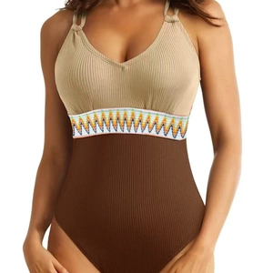 One-piece ribbed swimsuit in beige and brown with colorful zigzag waistband detail