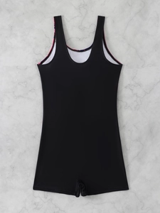 Racerback detail of a black one-piece swimsuit with colorful print on marble background
