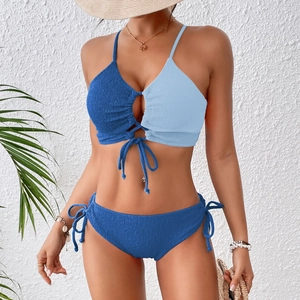 Detail view of the textured blue color-block bikini top with adjustable tie-up front