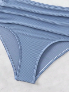 Close-up of light blue high-waisted bikini bottoms with ribbed fabric and pleated texture