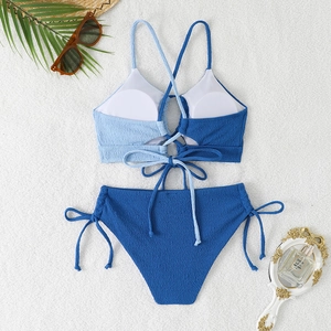 Close-up of blue color-block bikini set with textured seersucker fabric and lace-up ties