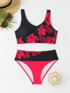 Detail of high waist floral bikini set with red hibiscus print on smooth black fabric