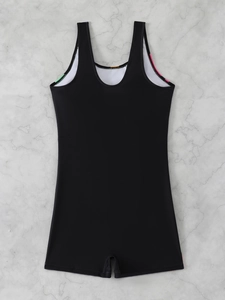 Detail view of one-piece black swimwear with side color stripes on marble background