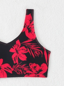 Detail of red floral print on black bikini top with reinforced stitching and soft lining