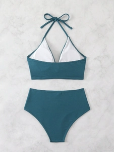Detailed view of dark teal ribbed bikini top with halter neck and removable padding inserts