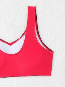 Detailed close-up of red bikini top with durable double-stitch seams and white lining