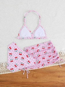 Detailed view of girls' cherry plaid bikini top with breast pads and ruffled skirt