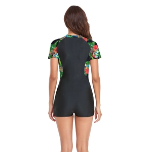 Rear view detail of women's short sleeve swimsuit featuring tropical pineapple print panels