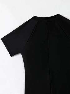 Detail view of the round neck and raglan sleeve stitching on this black surf swimsuit