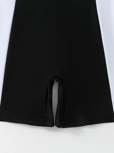 Macro shot showing double-needle flat-stitch hem on black athletic swimsuit fabric