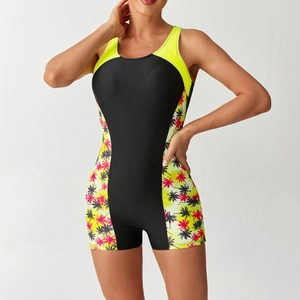 Detail of athletic boyleg swimsuit featuring black body with neon trim and palm print