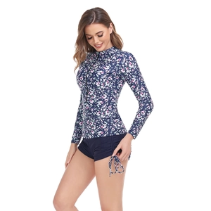 Detail view of the floral long sleeve rash guard with zipper and drawstring navy shorts