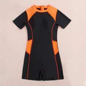 Flat lay of sporty one-piece short-sleeve swimsuit in black and vibrant orange patchwork