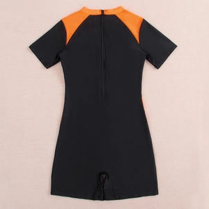 Detail view of athletic short-sleeve swimsuit with back zipper and orange color-blocking