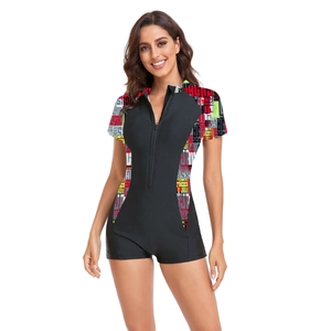 Close-up of women's short sleeve surf swimsuit with front zipper and side letter print
