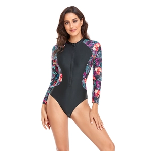 Front zipper detail of long sleeve surfing swimsuit with vibrant tropical floral prints